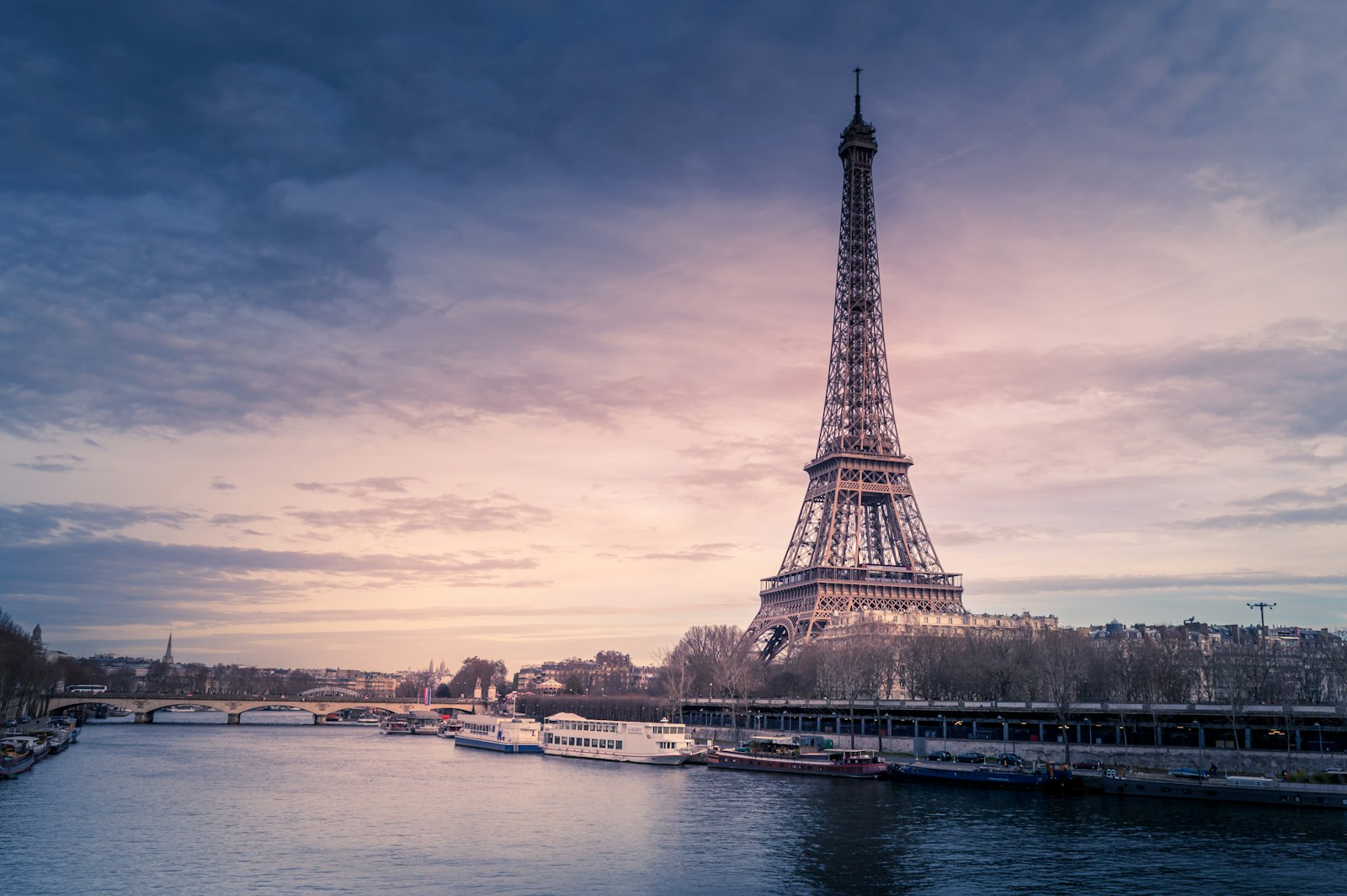 A city skyline with an iron tower at sunset